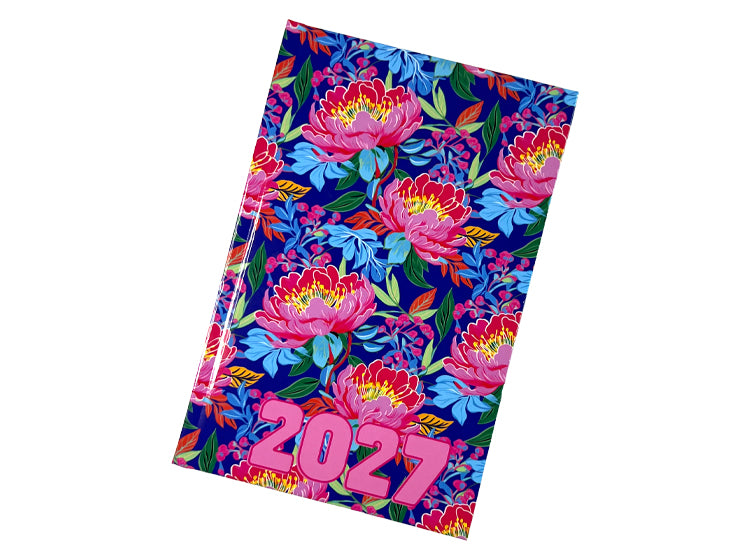 An Urban Nomad 2027 A5 page-a-day diary featuring a vibrant floral pattern with pink peonies on a dark navy blue background, shown at an angle on a white background.