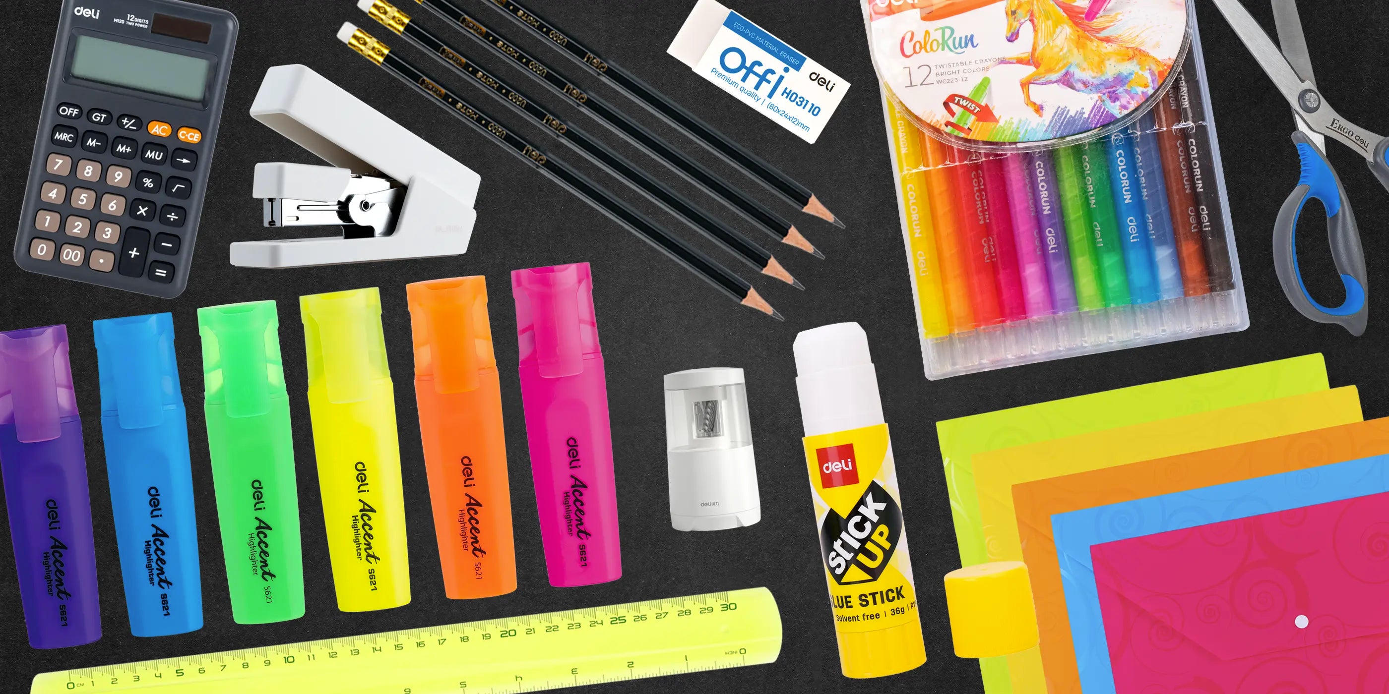 Colorful back to school stationery flat lay including twistable crayons, glue sticks, and HB pencils from The Inky Shop